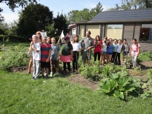Group of City Farm students posing in garden.